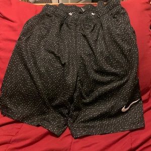 Boys black Nike shorts with just do it in small print all over